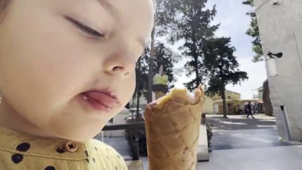 Little Girl Licks Ice Cream Waffle Cone Her Tongue High — Stockvideo