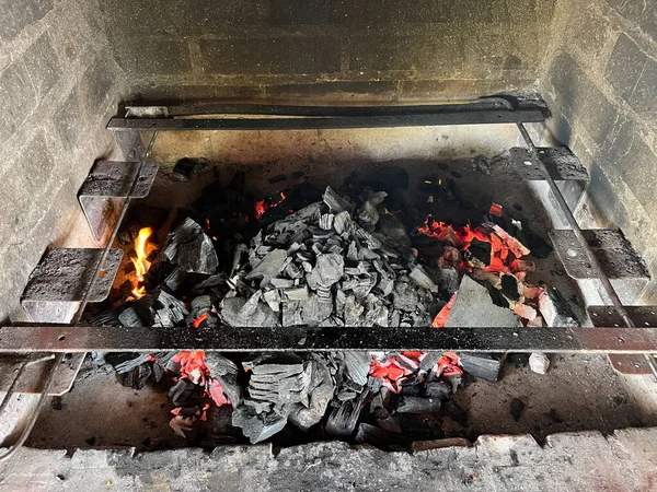 Burning coals inside a brick fireplace. High quality photo
