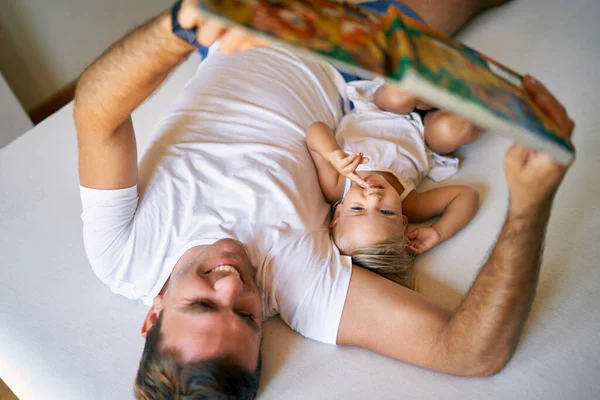 Dad Reads Fairy Tale Book Small Daughter While Lying Bed — Stockfoto