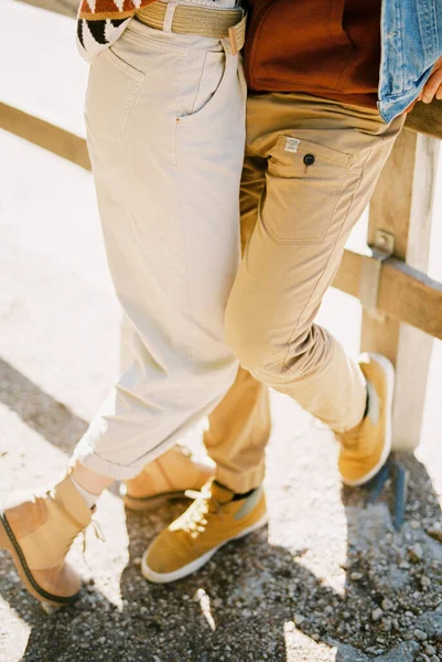 Legs of a man and a woman in trousers and boots. High quality photo
