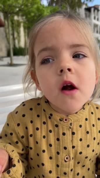 Little Girl Eats Ice Cream Cone Portrait High Quality Fullhd — Stockvideo