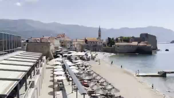 Sun Loungers Straw Umbrellas Beach Sveti Stefan Island High Quality — Stock video