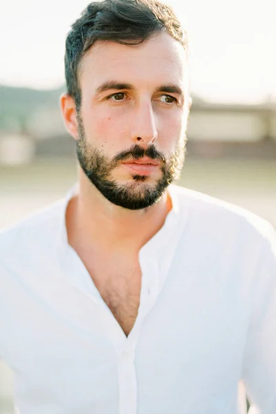 Bearded man in a white shirt. Portrait. High quality photo