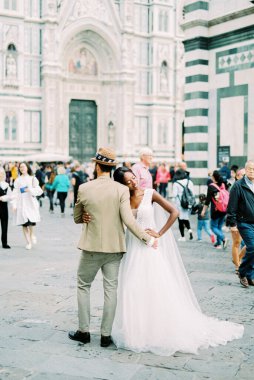 Bride and groom stand near the Cathedral of Santa Maria del Fiore. Florence, Italy. High quality photo