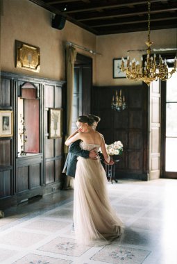 Bride and groom are dancing at the window of an old villa. Como, Italy. High quality photo