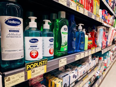 Liquid and solid soap stands on a shelf in a supermarket. High quality photo