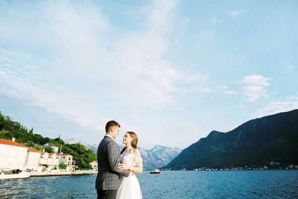 Groom Hugs Bride Waist Pier Backdrop Perast Embankment Montenegro High — стоковое фото