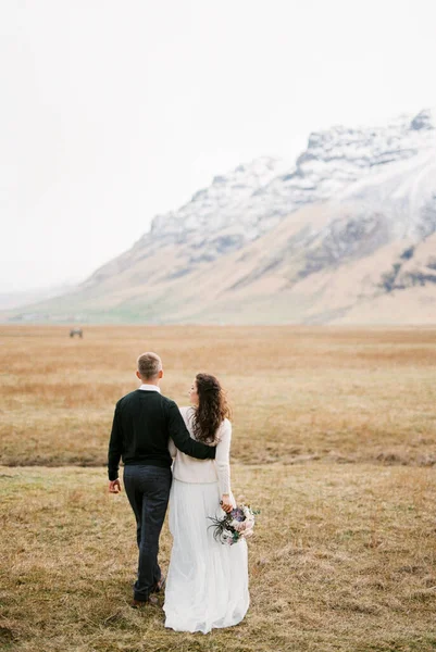 Groom Walks Bride Dry Meadow Foot Mountains Back View High — Photo