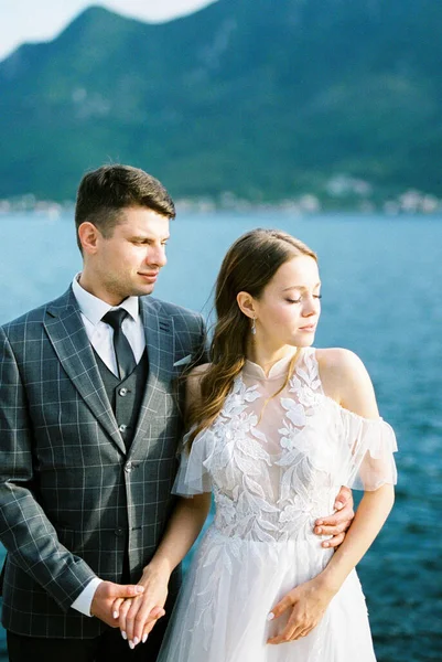 Groom Hugs Bride Waist Backdrop Mountains Sea Montenegro High Quality — стоковое фото