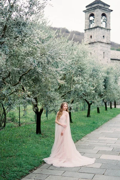 Bride Pink Dress Stands Green Olive Tree Grove Backdrop Chapel —  Fotos de Stock