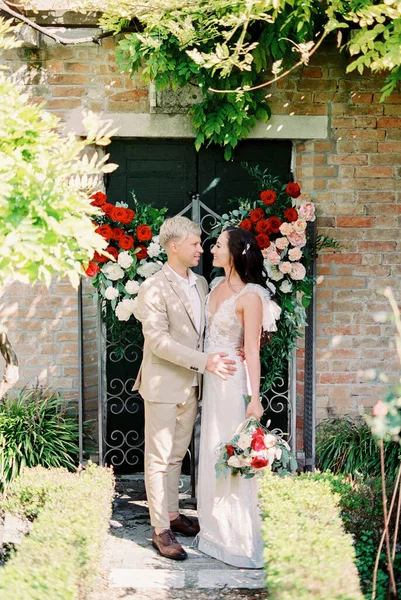Groom Hugs Bride Front Door Old Building Decorated Flowers High — Photo