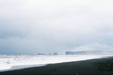 Black sand of Reynisfjara beach on the seashore. Iceland. High quality photo
