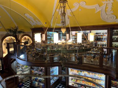 Large carved ceiling chandelier in a grocery store. High quality photo