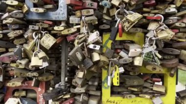 Colorful padlocks on a metal fence. Close-up. High quality 4k footage
