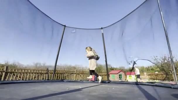 Little Girl Runs Trampoline Arena Playground High Quality Footage — Vídeo de Stock