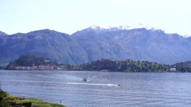 Motor boat sails on Lake Como against the backdrop of mountains. Italy. High quality 4k footage