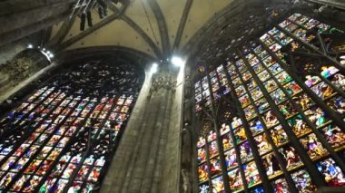 Colored stained glass windows on religious themes in the Duomo. Italy, Milan. High quality 4k footage