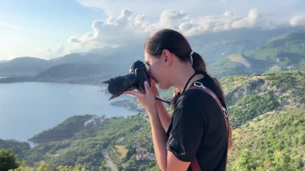 Girl Photographer Takes Pictures Backdrop Mountains Sea High Quality Footage — Vídeo de Stock