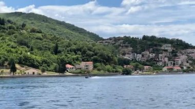 Small town at the foot of the green hills in the Bay of Kotor. High quality 4k footage