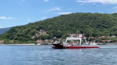 A car ferry sails along the Bay of Kotor. High quality 4k footage