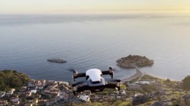 Drone hovering in the air is filming an island in the Bay of Kotor. High quality 4k footage