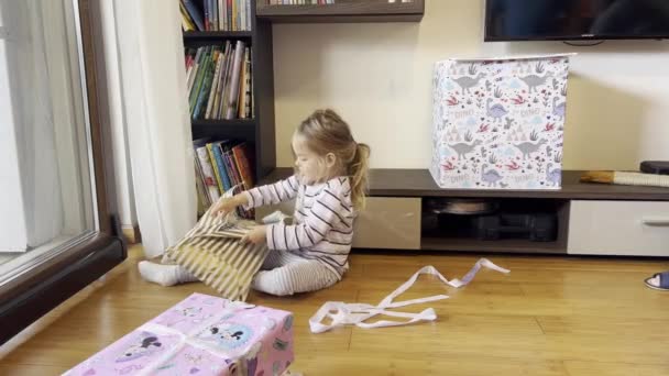 Little Girl Unpacks Gift Doll Sitting Floor Room High Quality — Stockvideo