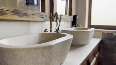 Marble washbasin with antique bronze faucet. High quality 4k footage