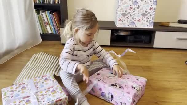 Little Girl Unties Ribbon Box Gift Sitting Floor Room High — Stock Video