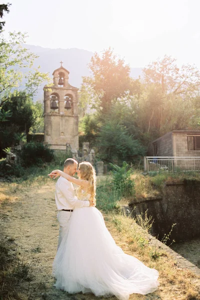 Groom Hugs Bride Stone Bell Tower Three Bells High Quality —  Fotos de Stock