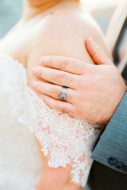 Groom hand on the bride shoulder. Close-up. High quality photo