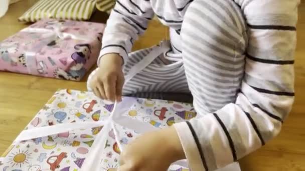 Little Girl Sits Floor Unties Ribbon Box Gift High Quality — Stock Video