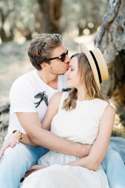 Man hugging and kissing a woman on the forehead. High quality photo