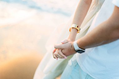 Man holds woman hand against the sky. Close-up. High quality photo