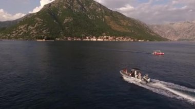 Şişme tekne Perast açıklarındaki St. George adasına doğru yüzüyor. Karadağ. Yüksek kaliteli FullHD görüntüler