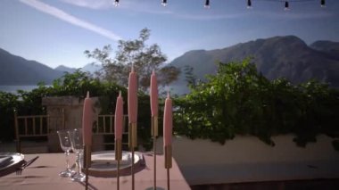 Mumlar deniz kıyısındaki terasta bir masanın üzerinde duruyor. Yüksek kaliteli FullHD görüntüler