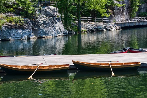 Two empty row boats tied to the boat dock at Mohonk Lake, New Paltz, New York.