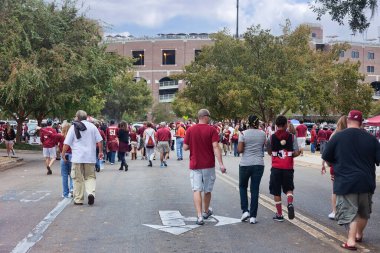 Tallahassee, Florida - November 16, 2013: Fans walking towards Doak Campbell Stadium to watch a Florida State University football game with the FSU Seminoles. clipart