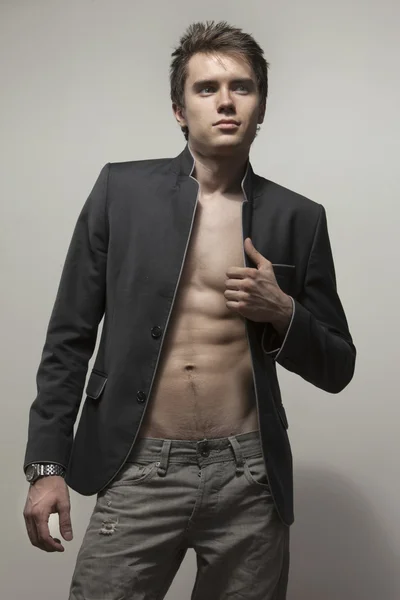 Young good-looking model in dark suite with naked torso — Stock Photo, Image
