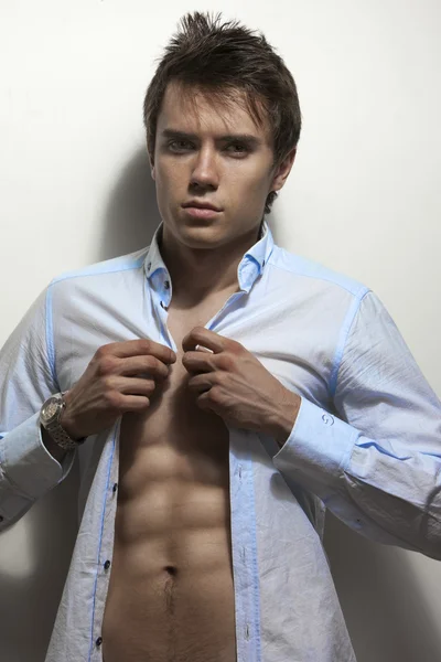 Sexy mannelijke fitness model in korte broek en blauwe shirt — Stockfoto