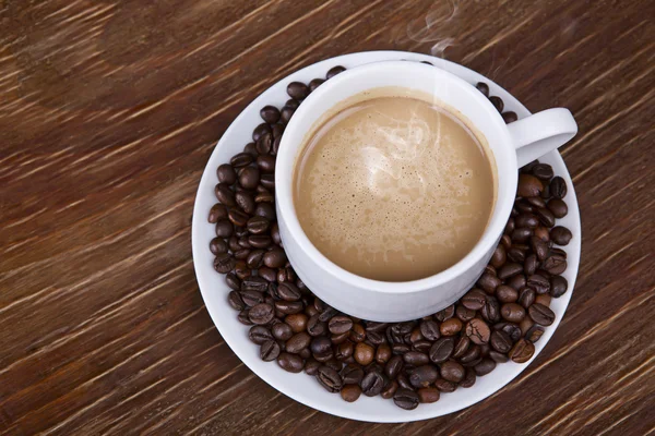 Coffee cup with beans — Stock Photo, Image