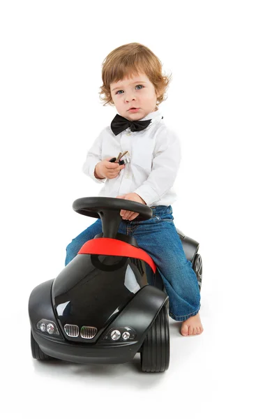 Boy driving a black toy car — Stock Photo, Image