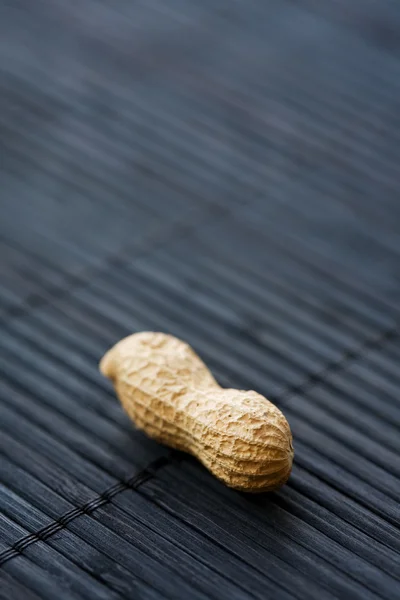 Peanut on black, close-up — Stock Photo, Image