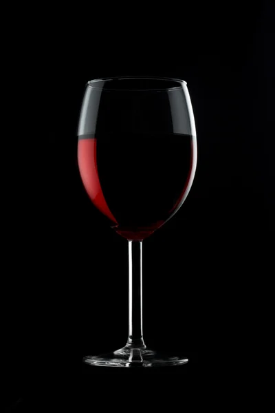 One glassed of red wine isolated on black background — Stock Photo, Image