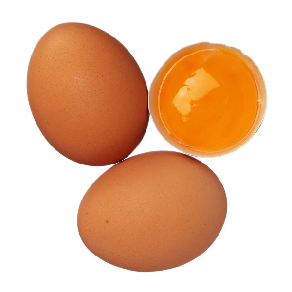 Hele eieren en eigeel in shell geïsoleerd op wit — Stockfoto