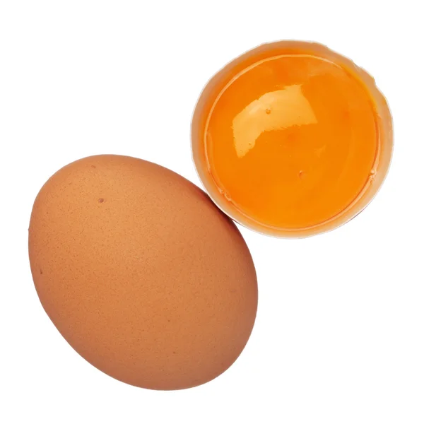 Whole egg and egg yolk in shell isolated on white — Stock Photo, Image