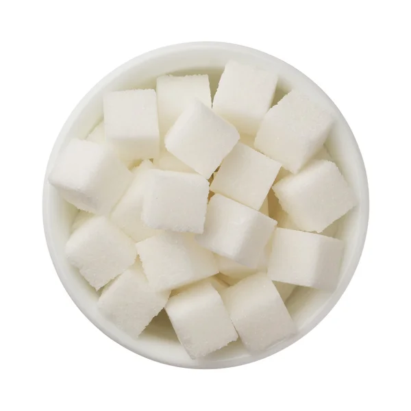 Sockerbitar i en skål som isolerad på vit bakgrund — Stockfoto
