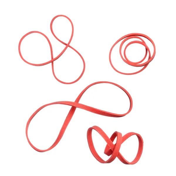 Gedraaide rode elastisch rubber bands geïsoleerd op witte achtergrond — Stockfoto