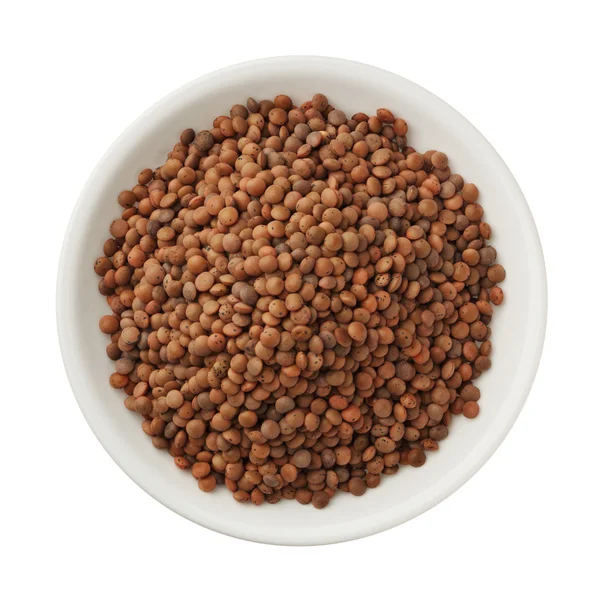 Uncooked lentils in a bowl isolated on white background — Stock Photo, Image