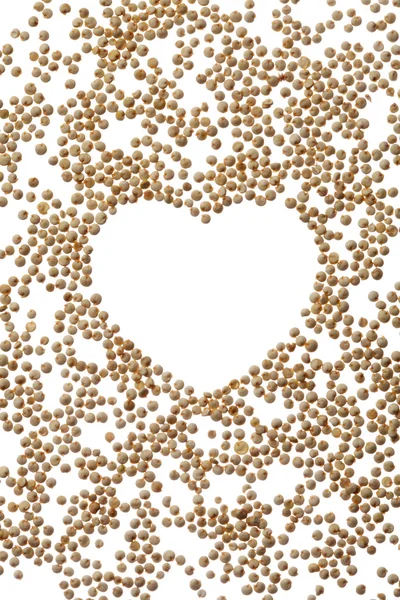 Uncooked quinoa heart frame on white — Stock Photo, Image