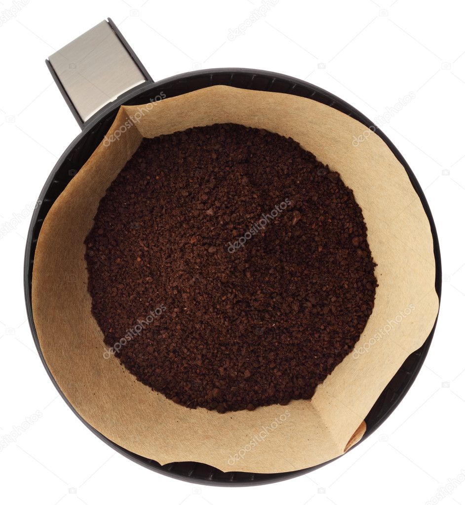 Ground coffee in filter holder isolated on white background over